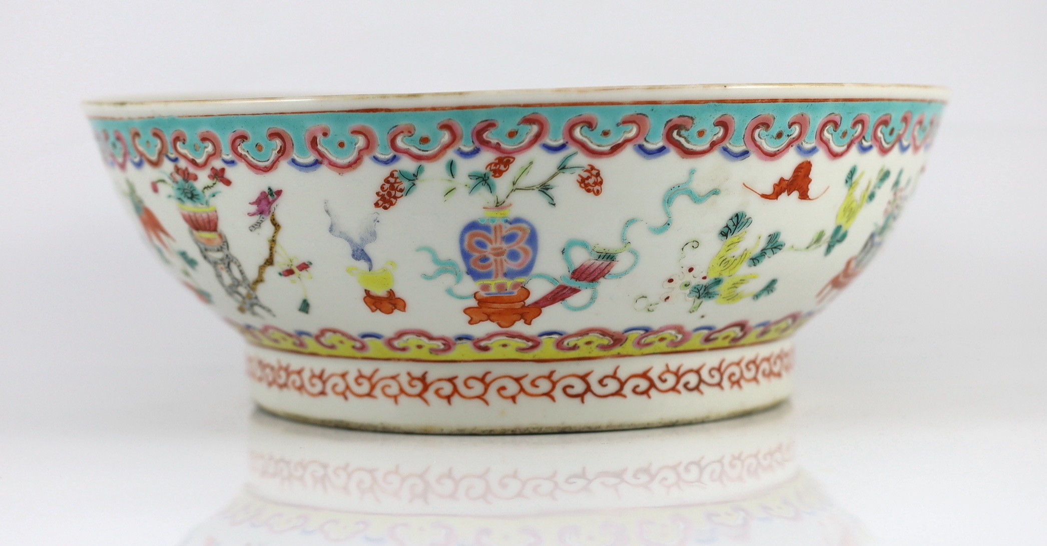 A Chinese famille rose ‘antiques and auspicious objects’ bowl, Chenghua mark, late 19th century, 26.7cm wide, mis-shapen